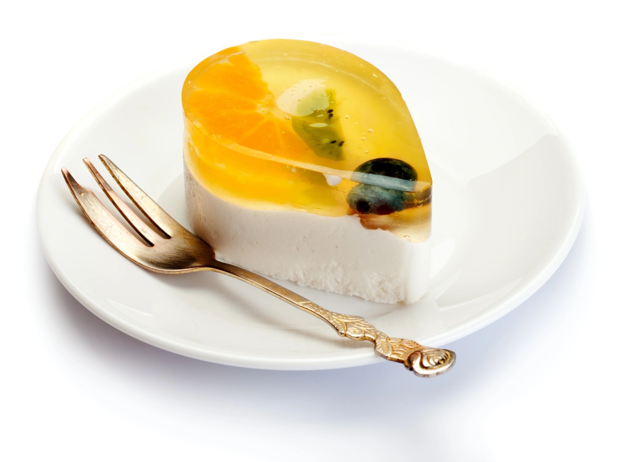 Fruit-topped jelly cake on a white plate